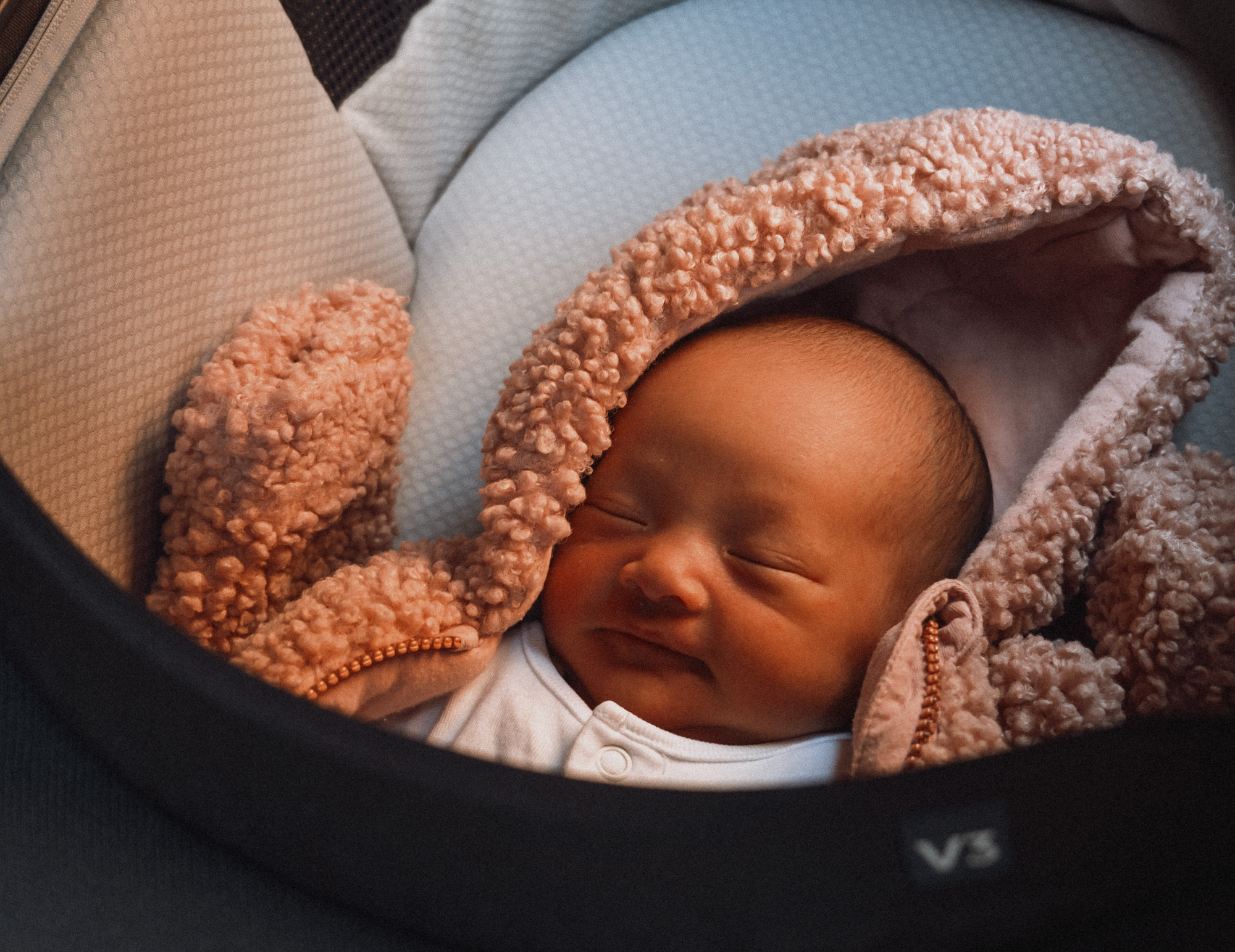 A 10-day old baby in a bassinet